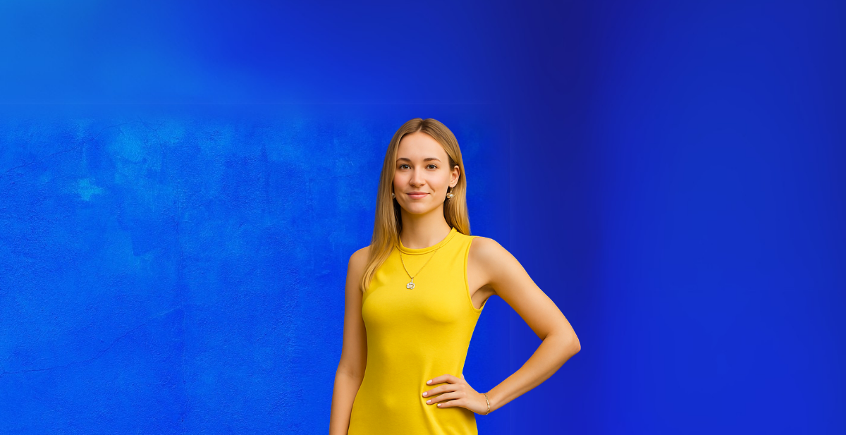 Woman in a yellow dress standing against a blue background