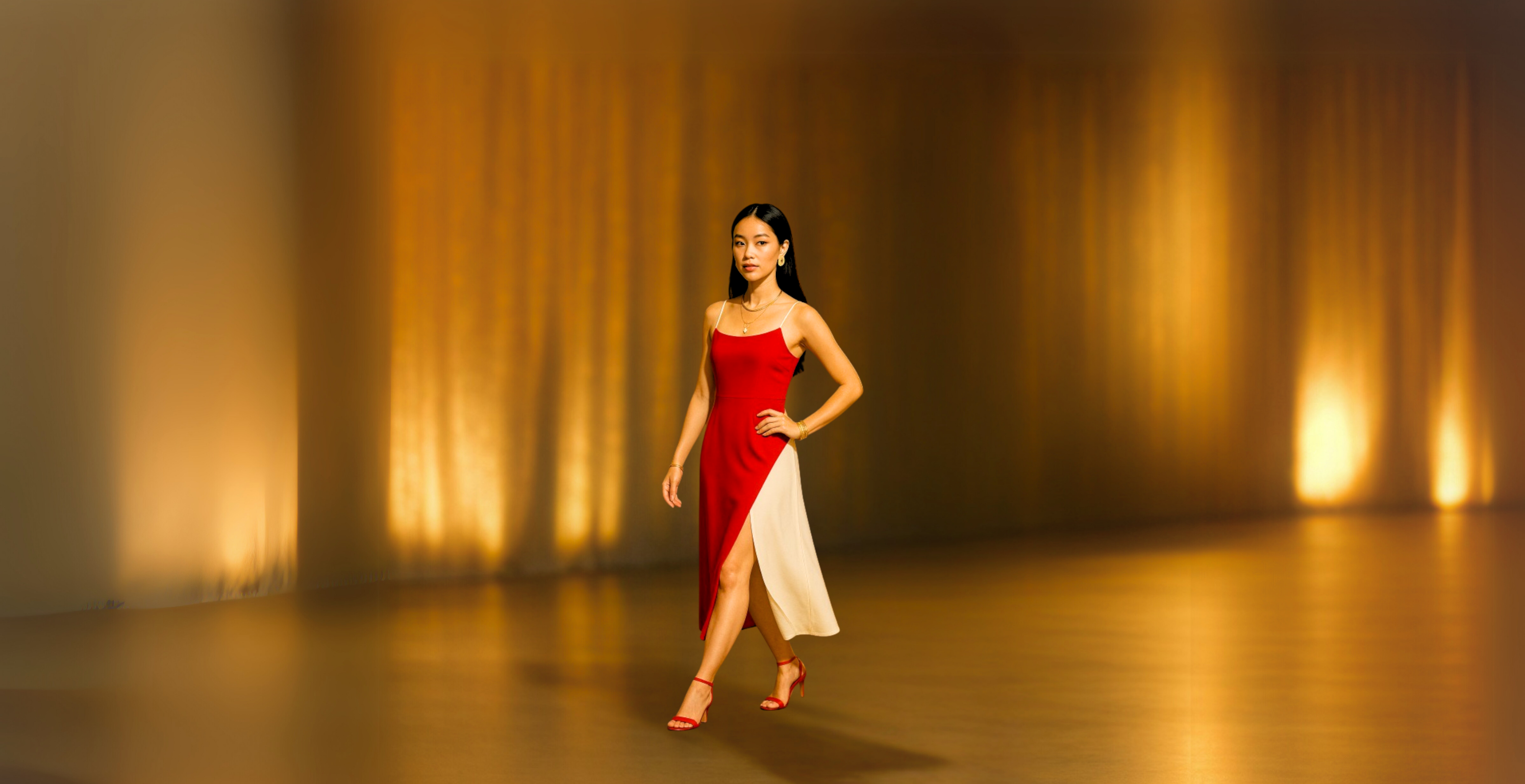 Woman in a red and white dress standing on a stage with warm lighting